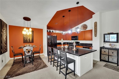Kitchen featuring black appliances, dark counterto