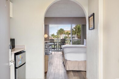 Bedroom featuring freestanding refrigerator, wood 