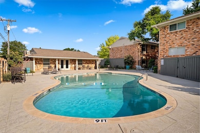 Community pool featuring a patio, fence, and frenc