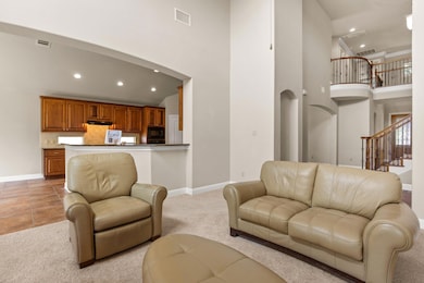 Living room with a towering ceiling, recessed lig