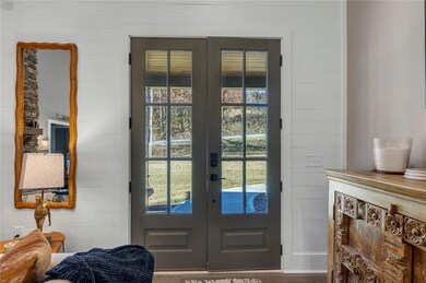 Bright space w/ trendy shiplap walls & beautiful double glass doors.