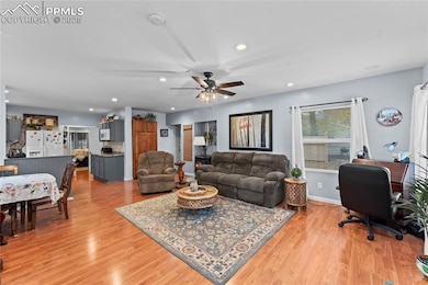 Living room featuring light wood-style floors, recessed lighting, a ceiling fan, and an office area