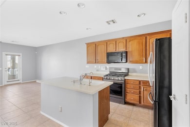 Kitchen with light countertops, light tile pattern