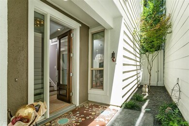 Front entry with gate to backyard. Texas black sta