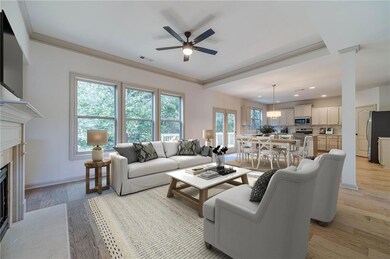 Living room with light wood-type flooring, a ceiling fan, a high end fireplace, ornamental molding, and recessed lighting