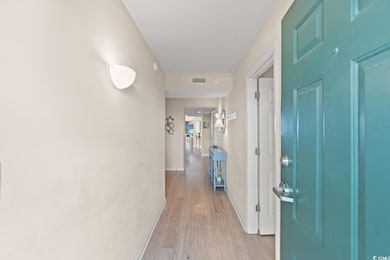 Corridor with light wood finished floors and baseboards