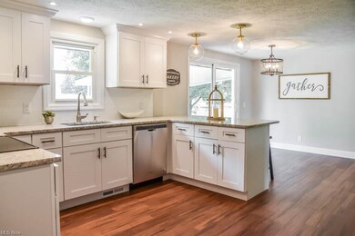 The kitchen has granite counters and subway tile b