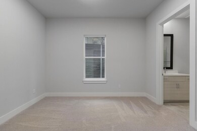 Spare room with light colored carpet and baseboard