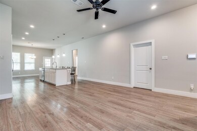 Unfurnished living room with ceiling fan with nota