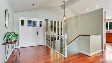 Vaulted entry open living spaces with large windows for ample natural light