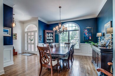 On trend blue accent wall with gleaming hardwood floors and large wall space for artwork and sideboard.  