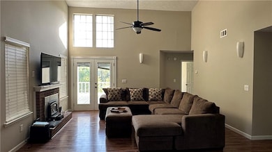 Living room featuring visible vents, baseboards, a