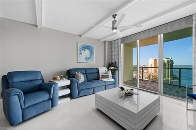 Tiled living room with a water view, beamed ceilin