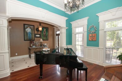 Formal dining room is currently being used as a piano room. Chandelier can be lowered for dining table.