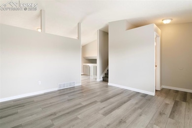 Empty room featuring light wood-type flooring, sta