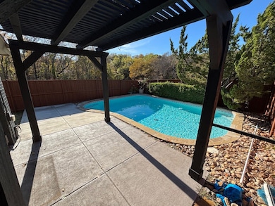 View of swimming pool featuring a pergola, a fenced backyard, and a patio