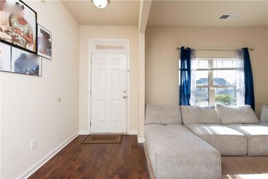 Foyer entrance with baseboards, visible vents, and