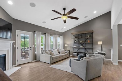 A wall of windows and an atrium door leading to the composite deck provide warm natural light and beautiful wood views!