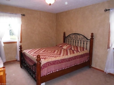 This bedroom has large double windows!