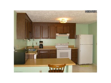 KITCHEN WITH BACK DOOR LEADING TO THE CONCRETE PAT