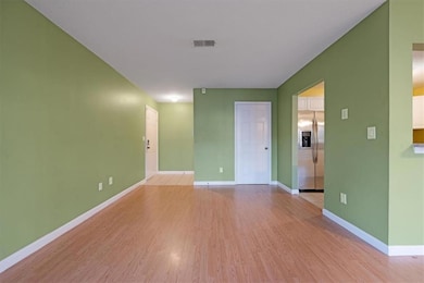 Empty room with light hardwood / wood-style floors