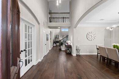 This elegant entryway features high ceilings, hard