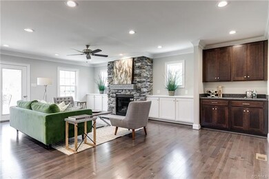 Family room with built-in cabinetry, gas fireplace and separate bar area.