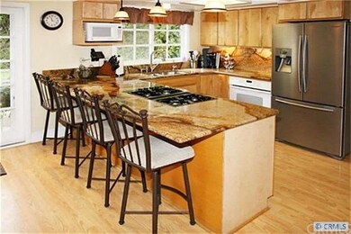 Plenty of counter seating at  the wide granite cou