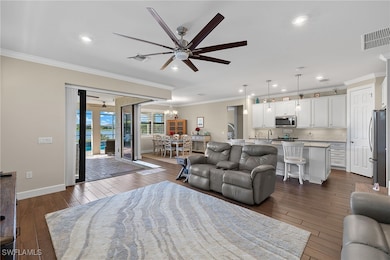 Living room featuring ceiling fan with notable cha