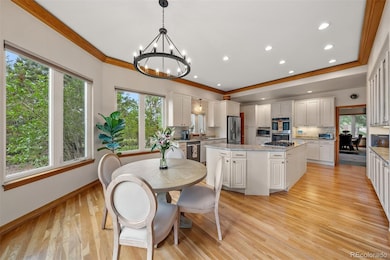 Bright and inviting kitchen with white cabinetry, granite countertops, a new gas cooktop, and a sunlit eat-in area overlooking the backyard.
