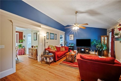 Living area featuring ceiling fan, light wood-type