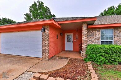 View of exterior entry with a garage