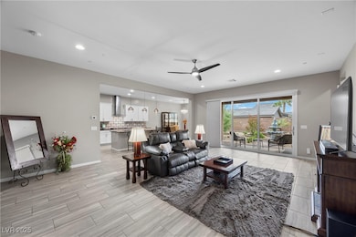 Living room with ceiling fan, recessed lighting, b