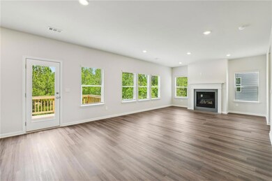 Unfurnished living room featuring dark wood-style 
