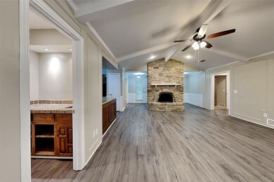 Unfurnished living room featuring a stone fireplac