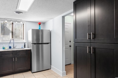 Kitchen with stainless steel refrigerator, sink, l