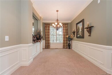 Dining room has chair rail and picture frame and c