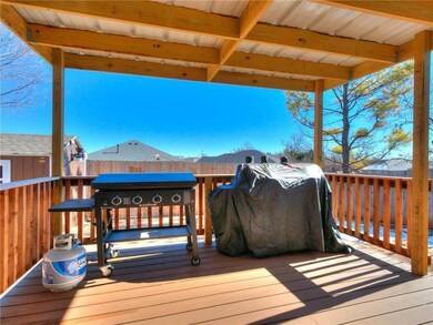 Wooden terrace with a shed, a grill, fence, and an