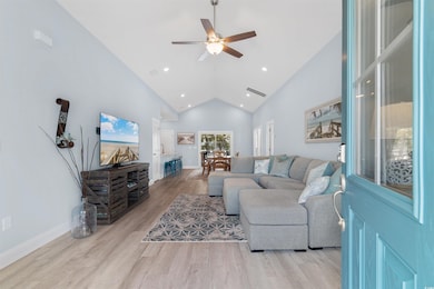 Living area featuring high vaulted ceiling, basebo