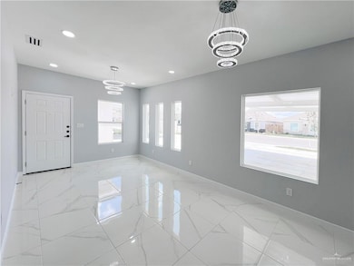 Unfurnished room featuring visible vents, marble finish floor, recessed lighting, baseboards, and a chandelier