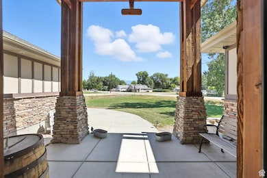 Covered porch featuring a yard