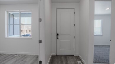 Entryway with baseboards and wood finished floors