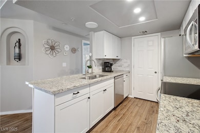 The Kitchen has all stainless steel appliances, white cabinets, with granite countertops.