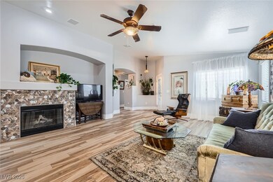Living area with arched walkways, a ceiling fan, w