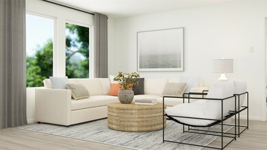 Living area with light wood-style flooring and baseboards