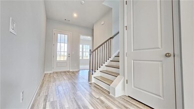 Entrance foyer with light wood finished floors and stairs