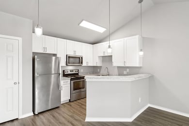Kitchen featuring white cabinets, and a bar top