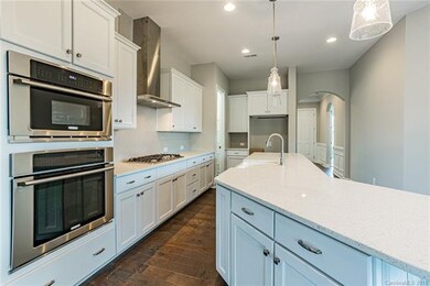 Gourmet kitchen with gas cooktop and farmhouse sin