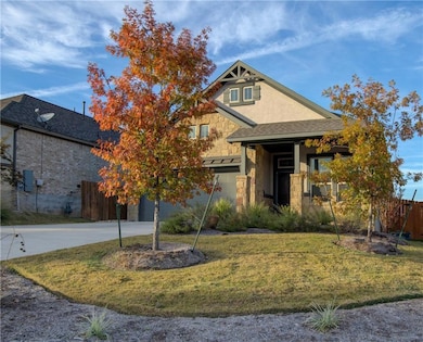 View of front of property featuring stone siding,
