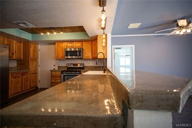 Kitchen with sink, ceiling fan, hanging light fixt